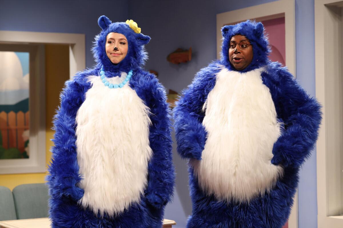 Two adults dressed up in blue and white bear suits