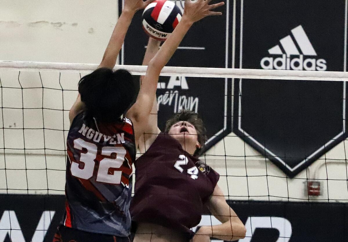 Ocean View's Tilo Voelkmann (24) spikes against Westminster's Jimmy Nguyen (32) in an Orange Coast League match on Thursday.
