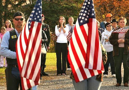 Kristy McNett, center, holds her hands in prayer as the casket of her uncle, Sgt. 1st Class Tony L. Knier, is taken to a memorial service Tuesday in Wellsboro, Pa. Knier was killed by a roadside bomb in Iraq.