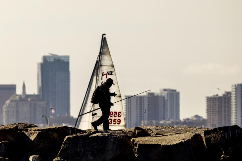 A fisherman at Alamitos Bay entrance jetty in Long Beach Tuesday, Sept. 19, 2023.