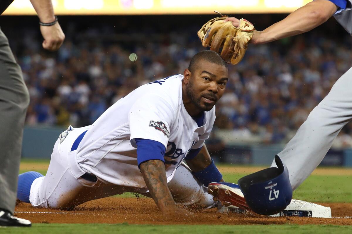 The Dodgers' Howie Kendrick steals third base in the fourth inning against the Chicago Cubs in Game 5 of the NLCS at Dodger Stadium on Oct. 20.