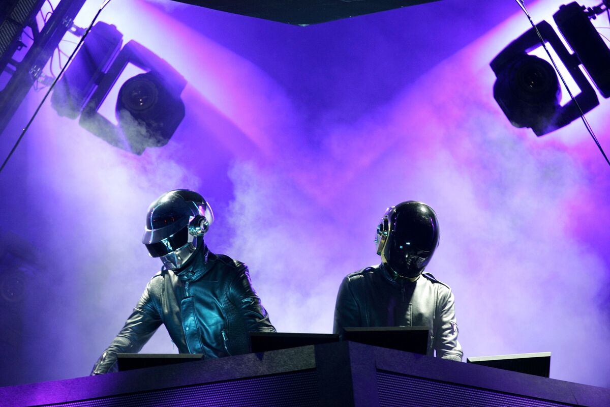 Two DJs in robot helmets