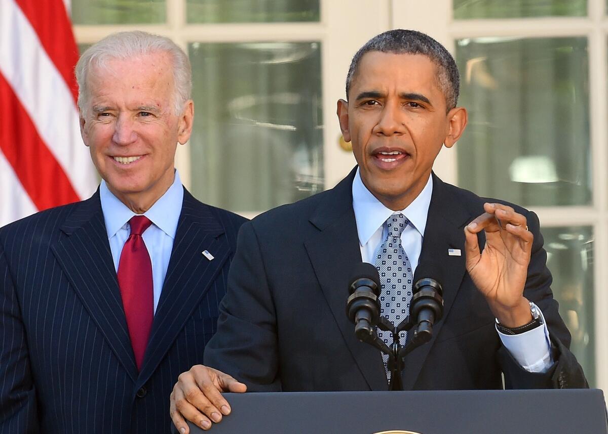 President Barack Obama is accompanied by Vice President Joe Biden as he delivers a statement on the Affordable Care Act at the Rose Garden of the White House in Washington, DC. Obama cheered seven million people who signed up for insurance under his healthcare law, and lashed out at political foes who he said were bent on denying care to Americans.