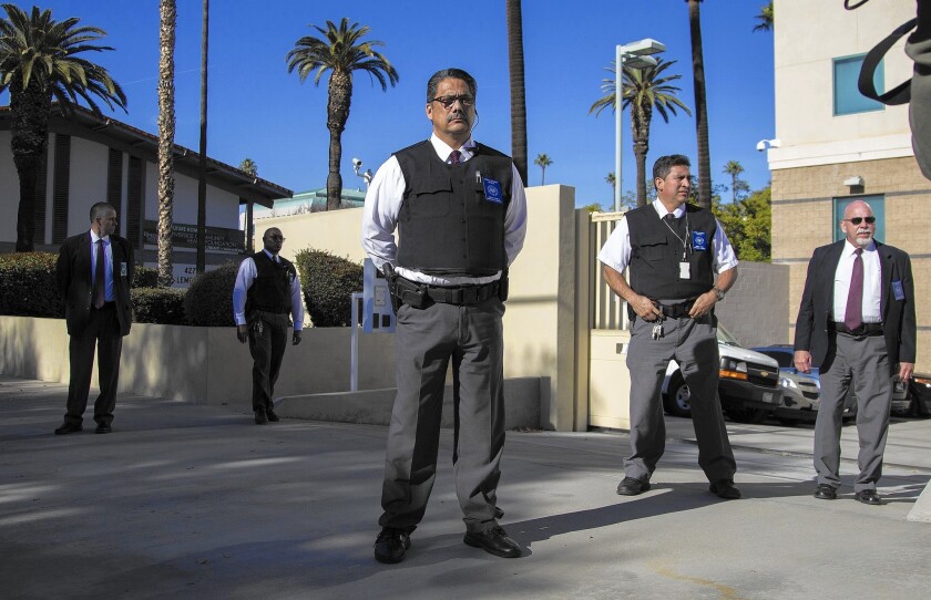 Riverside County court security officers stand guard after federal officials transported Enrique Marquez to a hearing, where he was charged in connection with two unfulfilled terrorism plots with the San Bernardino gunman.