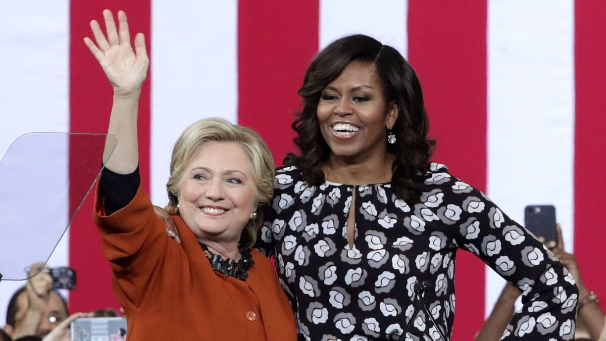 Democratic presidential nominee Hillary Clinton and First Lady Michelle Obama greet supporters Thursday in Winston-Salem, N.C.