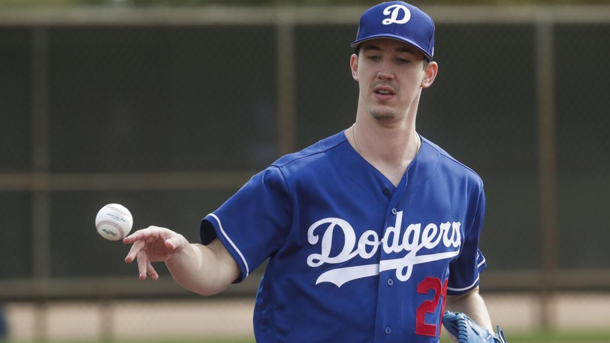 Dodgers pitcher Walker Buehler flips the ball during a spring training drill last month.