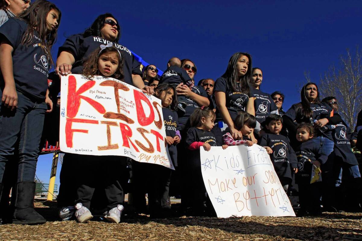 Parents of children at Desert Trails Elementary School in Adelanto rally at a local park in January before presenting a petition to the principal.