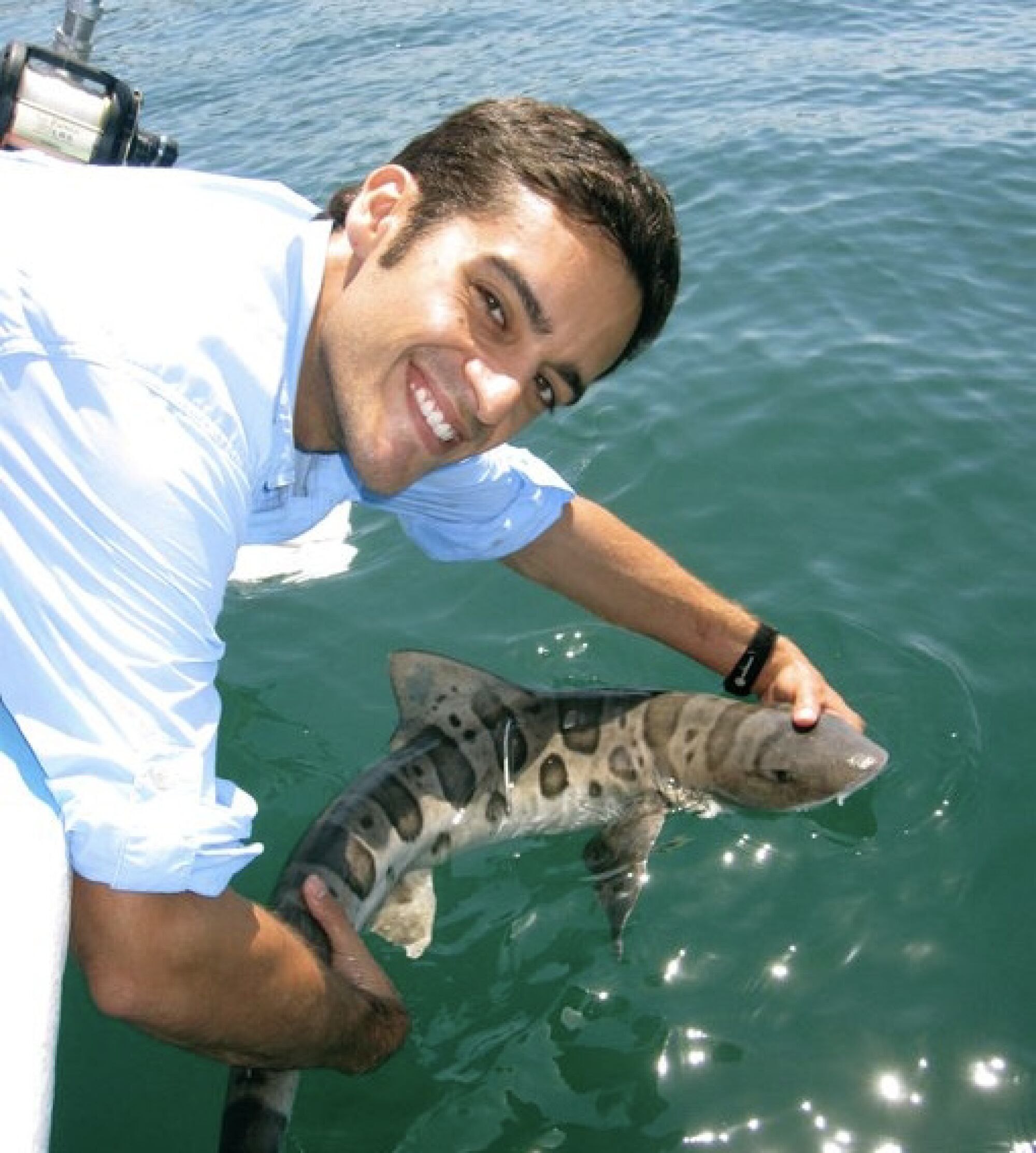 Marine science Andy Nosal of Point Loma Nazarene University holds a leopard shark. 