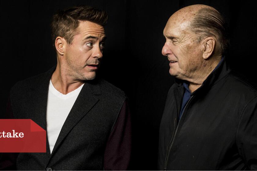 Actors Robert Downey Jr., left, and Robert Duvall talk about their movie "The Judge" at an Envelope Screening Series showing at the ArcLight Cinemas in Sherman Oaks.