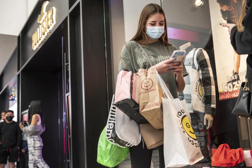 GLENDALE CA NOVEMBER 26, 2021 — Kayla Wrobel of Burbank take a break from shopping on Black Friday at the Glendale Galleria in Glendale, Calif. on Friday, Nov. 26, 2021. ( Nick Agro / For The Times )