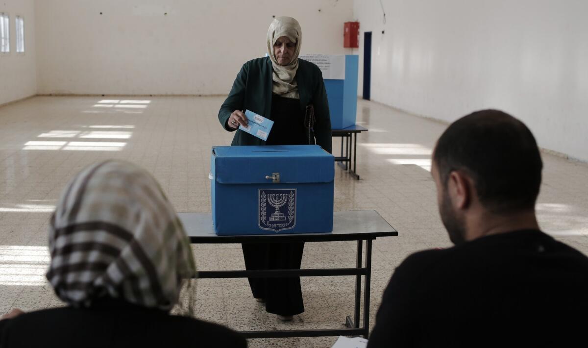 An Israeli citizen casts her ballot at a polling station in the northern town of Umm al-Fahm on March 17.