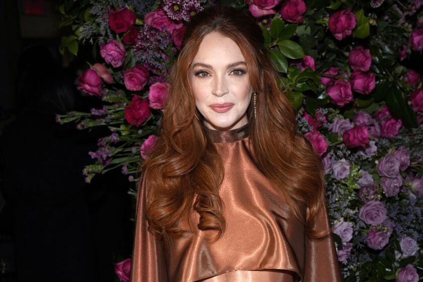 FILE - Actress Lindsay Lohan appears at the Christian Siriano Fall/Winter 2023 fashion show in New York, Feb. 9, 2023. The Securities and Exchange Commission said Wednesday, March 22, that Lohan, rapper Akon and several other celebrities have agreed to pay tens of thousands of dollars to settle claims that they promoted crypto investments to their millions of social media followers without disclosing they were being paid to do so. (Photo by Charles Sykes/Invision/AP, File)