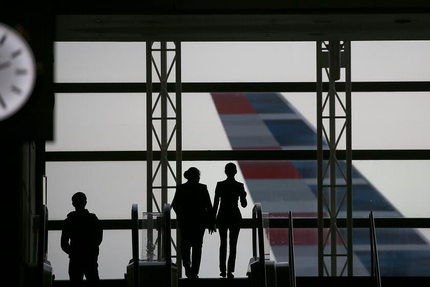 Los Angeles, CA - People are silhoutted against the windows at Tom Bradley International Terminal at LAX on Wednesday, Dec. 27, 2023. Travel experts say this weekend will produce a surge in air passengers as people head home from their holiday trips. (Luis Sinco / Los Angeles Times)