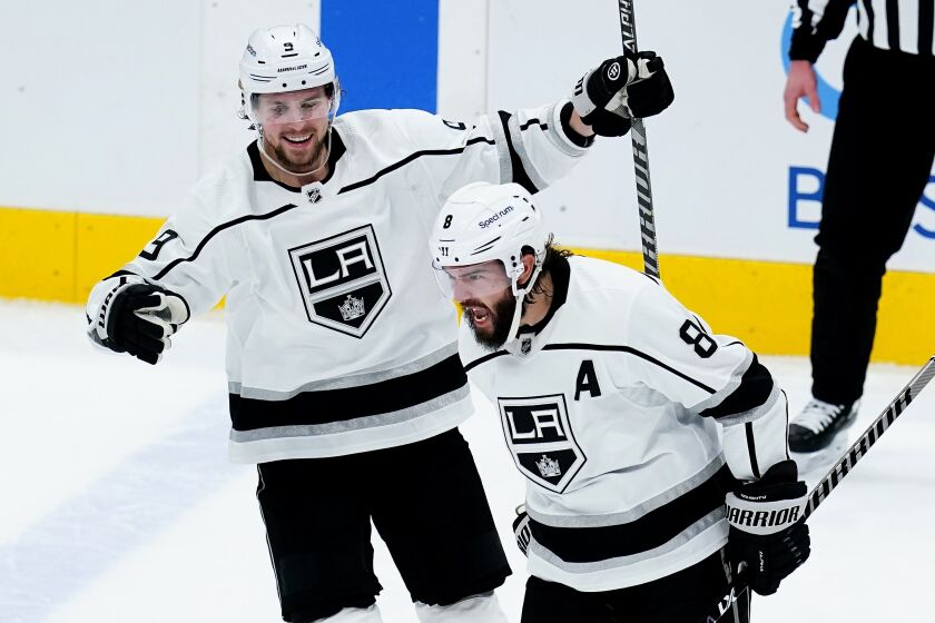 The Kings' Drew Doughty, right, shouts after his third-period goal against the Arizona Coyotes. Adrian Kempe is at left.