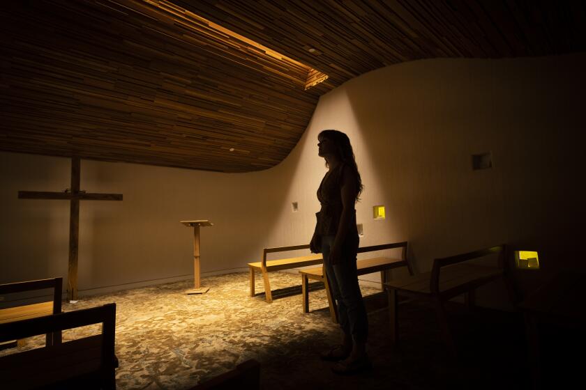 La Mirada, CA - March 20: Biola University student Sophie Byerly takes in the solitude of the Fred and Ruth Waugh Prayer Chapel at Biola University Sunday, March 20, 2022. A group of students and former students who attend Biola University in La Mirada are meeting off campus to talk about the questions they have about their faith. Their group is called the St. Thomas Collective. (Allen J. Schaben / Los Angeles Times)