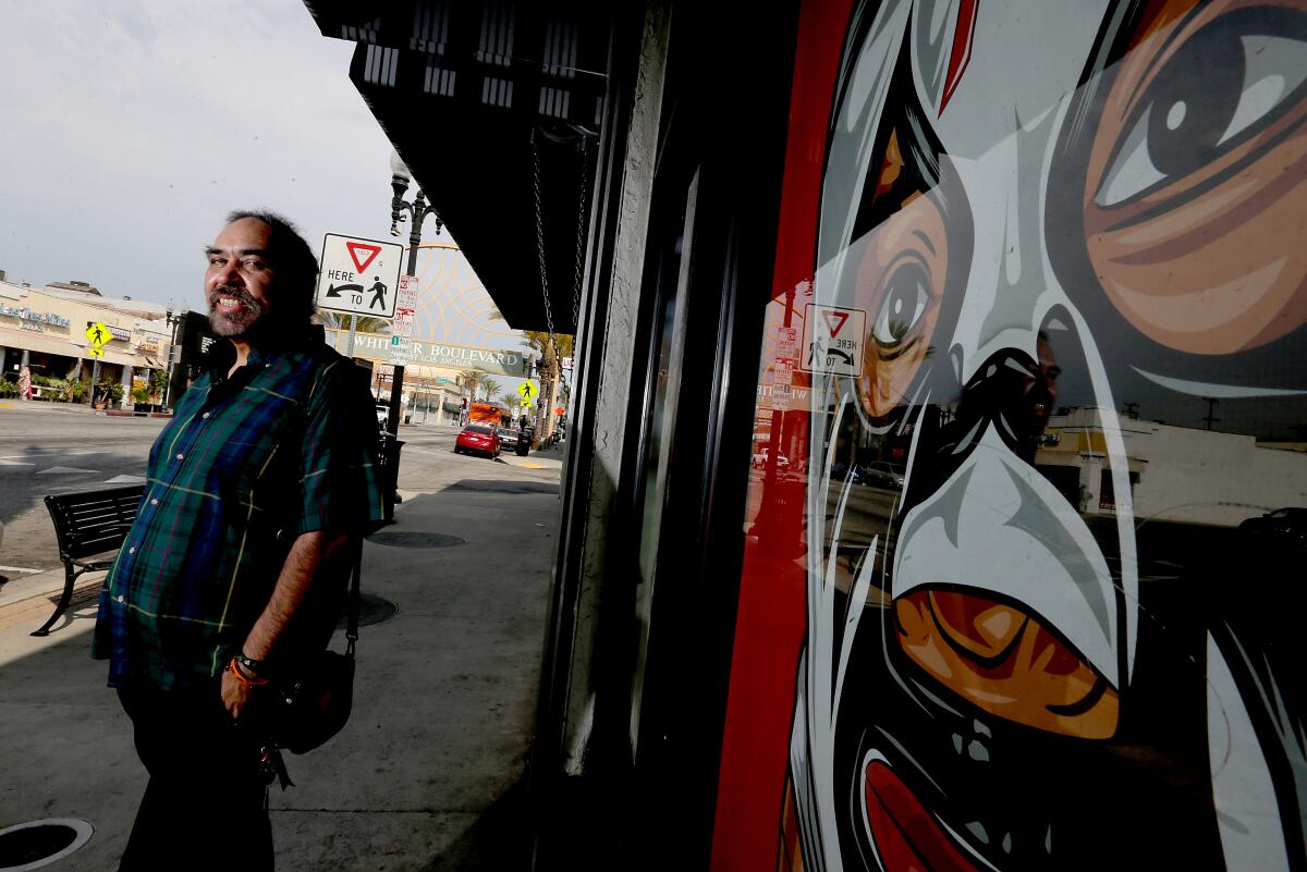 Artist Al Guerrero Jr., a native of East Los Angeles, stands along Whittier Boulevard. 