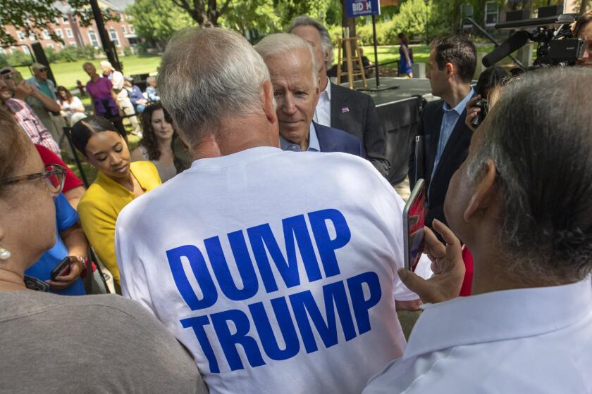 Democratic presidential candidate former Vice President Joe Biden speaks with a supporter during a campaign event at Keene State College in Keene N.H., Saturday, Aug. 24, 2019. (AP Photo/Michael Dwyer)