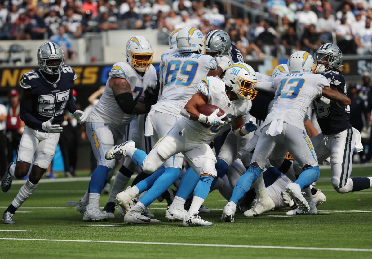 Chargers running back Austin Ekeler looks for a hole to punch through the Dallas Cowboys' defensive line.