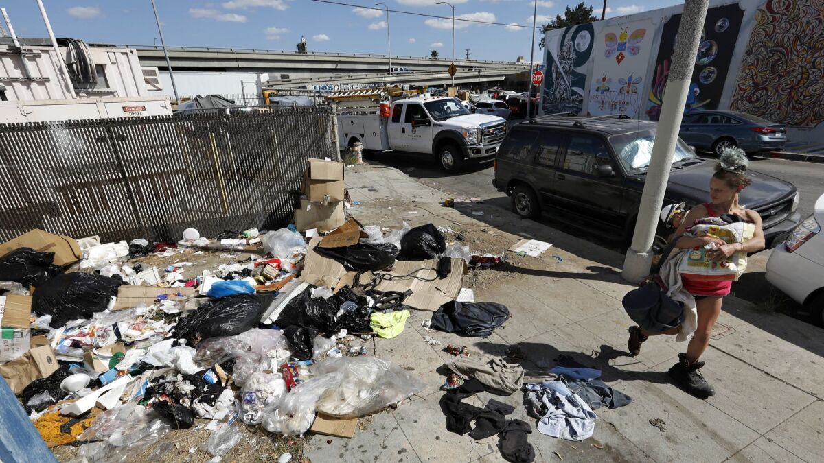 A pile of trash sits uncollected on Santee Street between 18th Street and Washington Boulevard in the Fashion District of Los Angeles on Oct. 11, 2018.