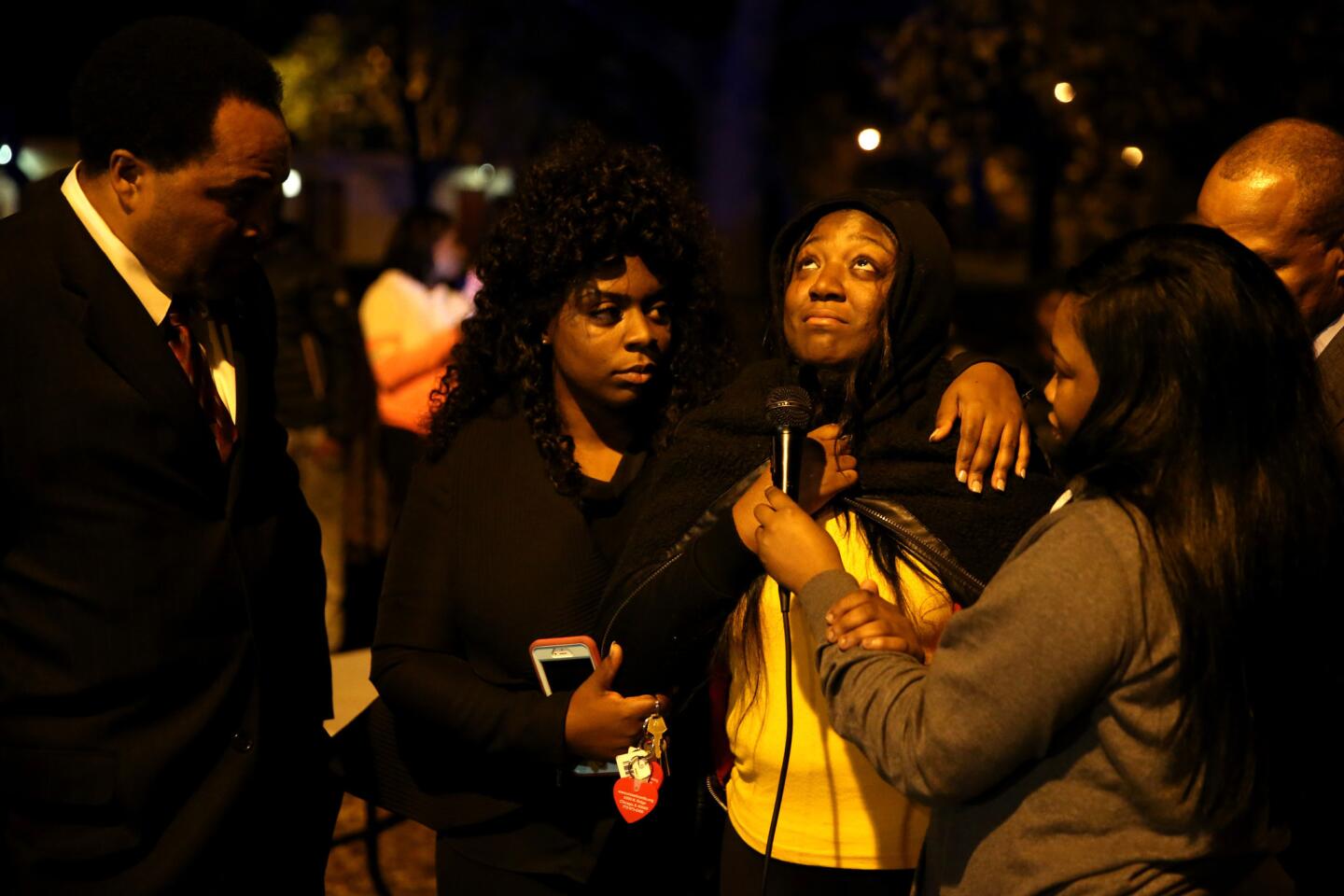 Karla Lee, center, speaks to Auburn Gresham community residents at an Operation: Wake Up! event put on by the Chicago Police Department in the 8000 block of South Damen Avenue on Nov. 3, 2015. Lee's son, Tyshawn Lee, 9, was shot and killed in a nearby alley on Nov. 2.