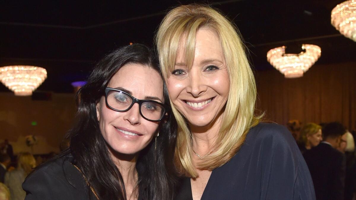 Courteney Cox, left, and gala host Lisa Kudrow have a "Friends" moment at the UCLA Semel Institute's Open Mind Gala at the Beverly Hilton.