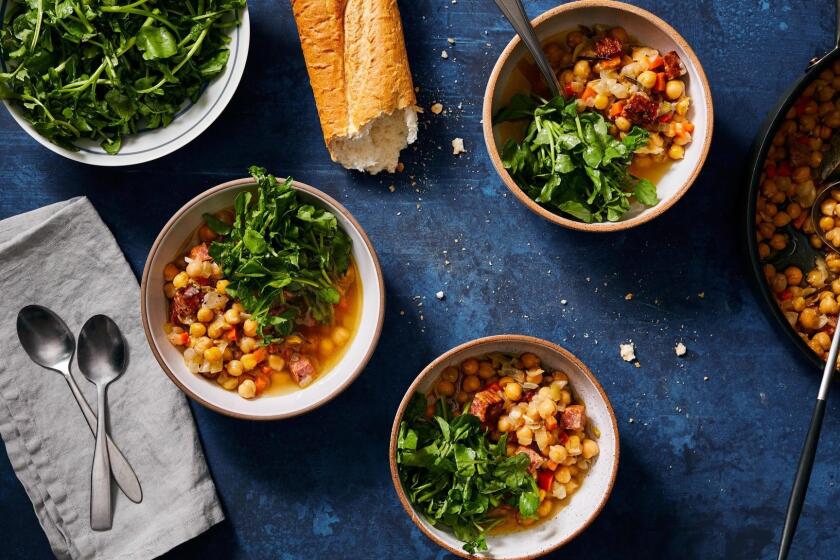 Canned chickpeas, baked in chicken broth with aromatics, are served up with bracing, crunchy watercress dressed with lemon. 