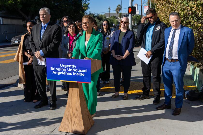 LOS ANGELES, CA - DECEMBER 06: Mayor Karen Bass, accompanied by Richard J. Monocchio, left, HUD Principal Deputy Assistant Secretary, and Los Angeles City Council members Nithya Raman, extreme left, Hugo Soto-Martinez and Bob Blumenfield, addresses a press conference on a city block cleaned from houseless persons on 6600 block of Selma Avenue on Wednesday, Dec. 6, 2023 in Los Angeles, CA. (Irfan Khan / Los Angeles Times)