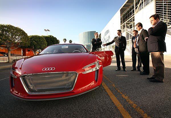 Audi executive Frank Van Meel, center, points out features of the e-Tron concept vehicle, which is slated to make its North American debut at the L.A. Auto Show.