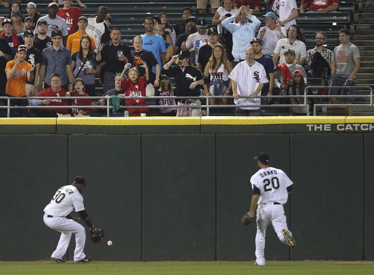 Fans in left field react to the three-run double hit by the Orioles' Jonathan Schoop during the eighth inning.
