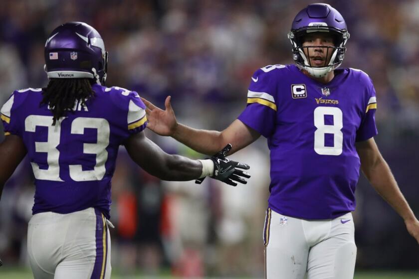 Minnesota Vikings running back Dalvin Cook (33) slaps hands with quarterback Sam Bradford (8) during an NFL football game against the New Orleans Saints, Monday, Sept. 11, 2017, in Minneapolis. The Vikings won 29-19. (Jeff Haynes/AP Images for Panini)