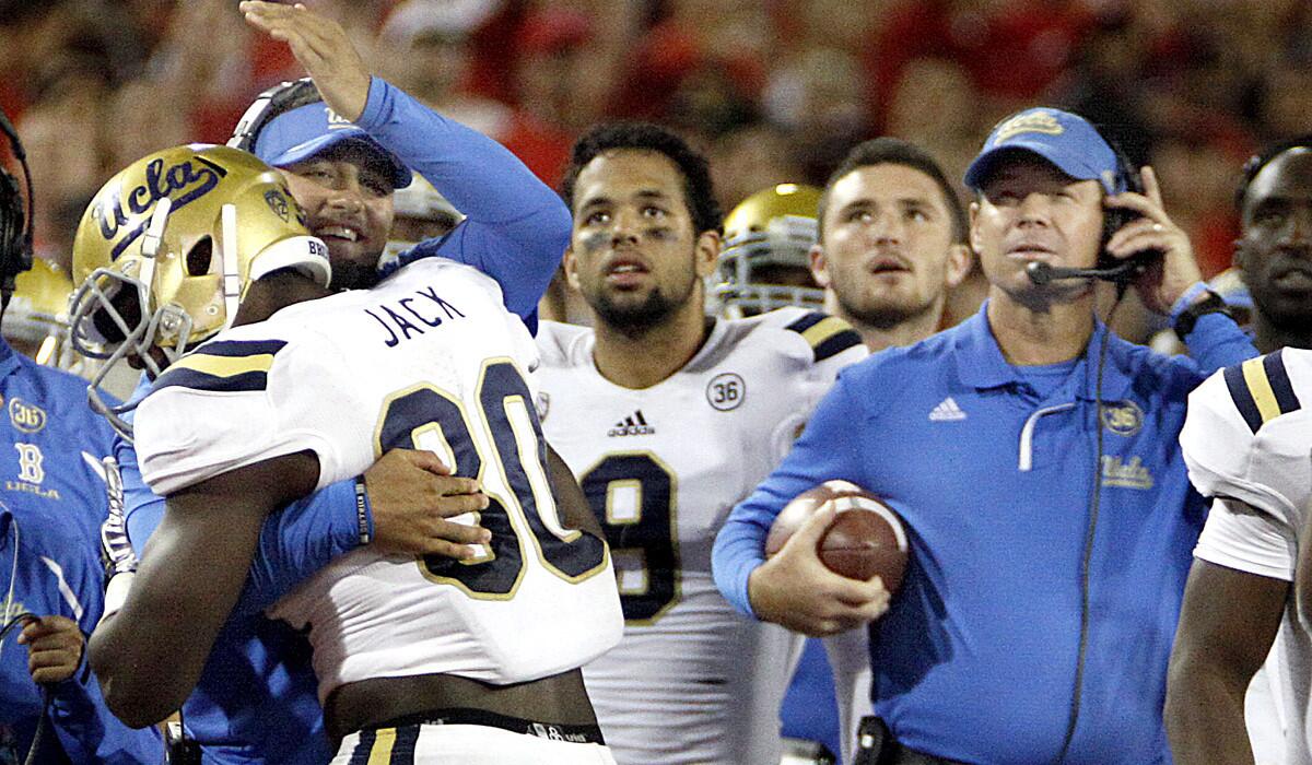 UCLA defensive coordinator Jeff Ulbrich congratulates linebacker Myles Jack after he recovered a fumble during a 2013 victory over Arizona.