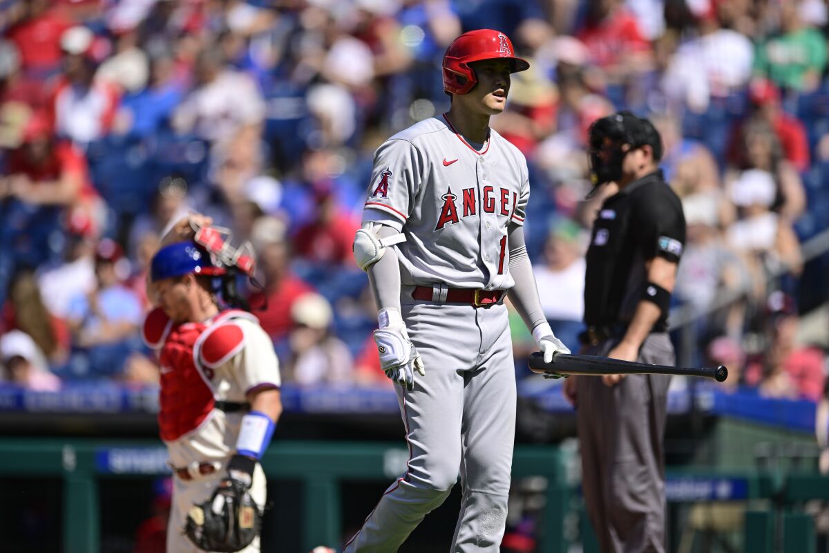 Shohei Ohtani walks back to the dugout after striking out