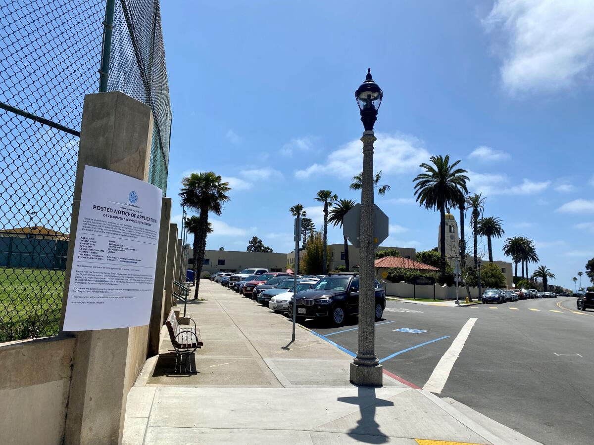 A larger-than-standard notice of application describing plans to vacate Cuvier Street faces the street.