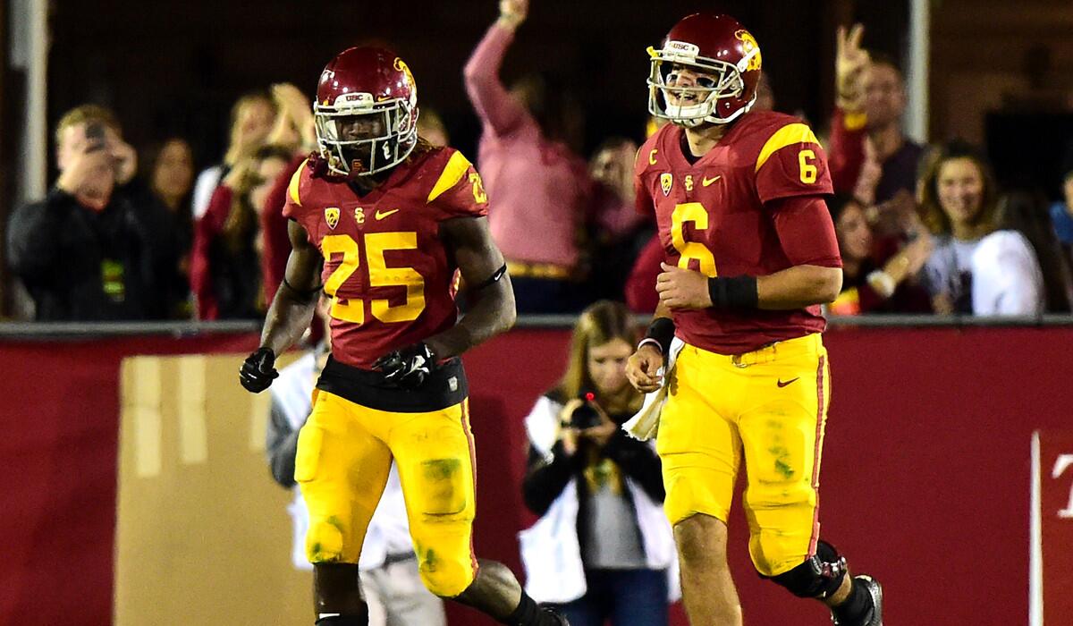 USC's Ronald Jones II, left, reacts to his 74-yard touchdown run with Cody Kessler during the fourth quarter at Los Angeles Coliseum on Saturday.