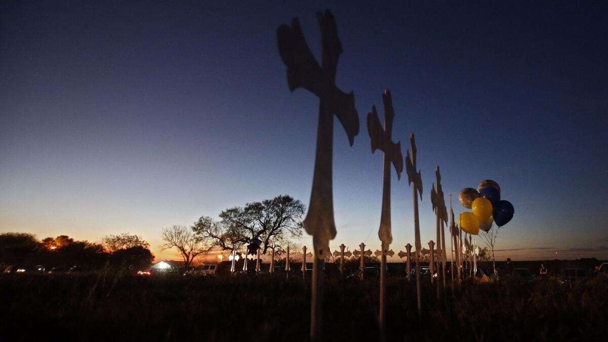 Twenty-six crosses stand on a field, representing the 26 victims of the shooting, at the First Baptist Church in Sutherland Springs, Texas.