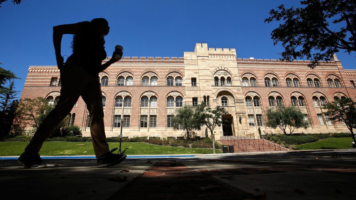 A student walks near the Humanities Building on the UCLA campus in Los Angeles on June 20, 2013.