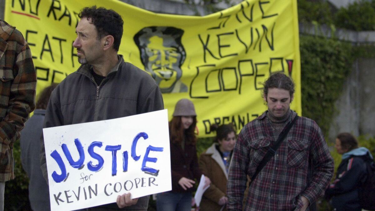 Musician Jonathan Richman, left, joins a group of anti-death penalty advocates attending a rally for Kevin Cooper in downtown San Francisco on Feb. 3, 2004.