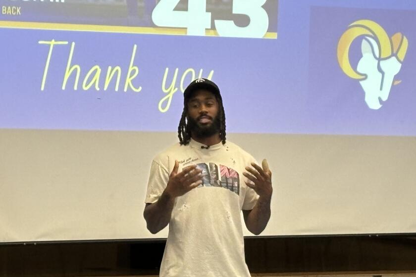 Rams safety John Johnson III speaks to children at the Edwin Markham Middle School in Watts.