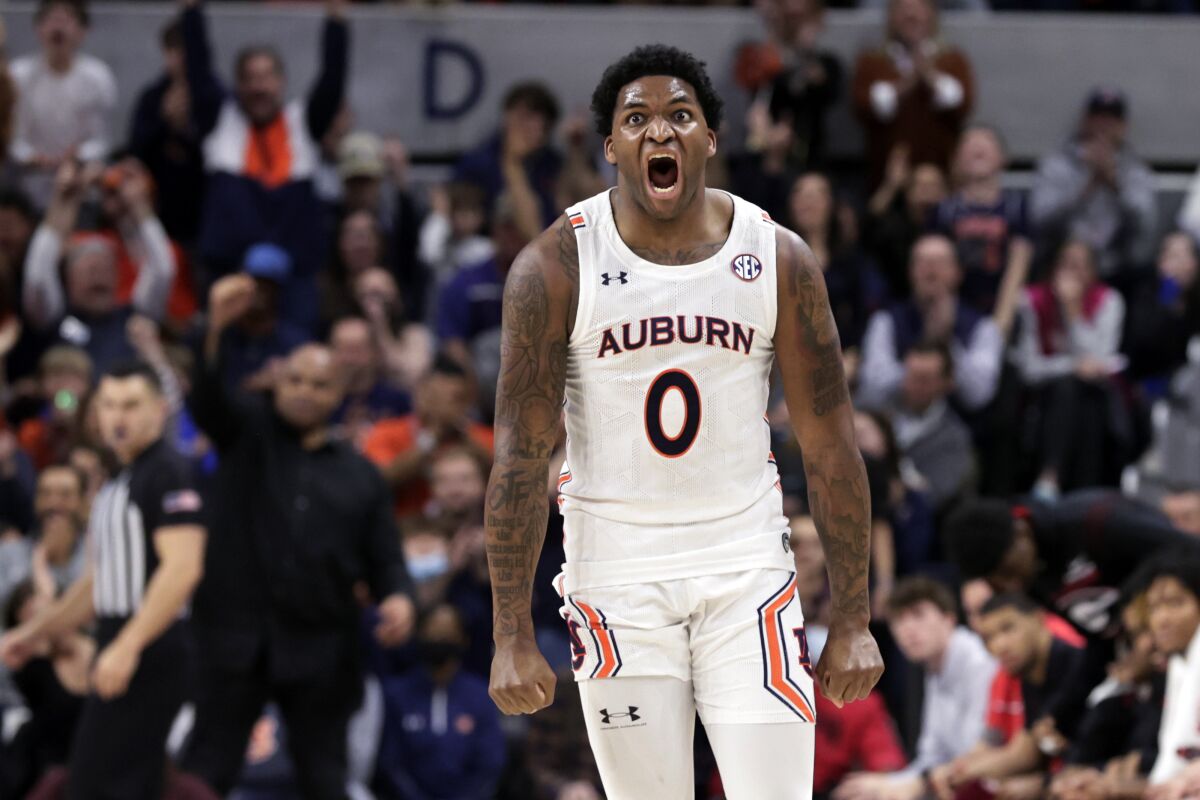 Auburn guard K.D. Johnson (0) reacts after making a 3-pointer against Georgia during the first half of an NCAA college basketball game Wednesday, Jan. 19, 2022, in Auburn, Ala. (AP Photo/Butch Dill)