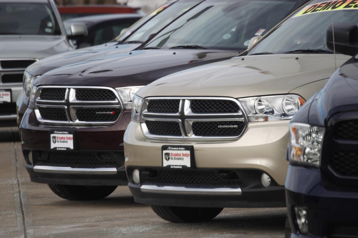 In this Sunday, Jan. 20, 2013, file photo, a line of unsold 2012 Durango sports-utility vehicles sits at a Dodge dealership in Littleton, Colo. Chrysler Group is adding more than 467,000 Dodge and Jeep SUVs worldwide to a 2014 recall to fix a potential stalling problem.