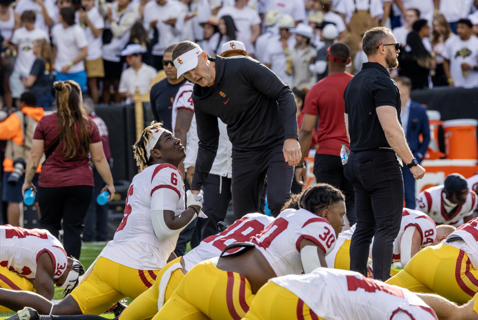 USC coach Lincoln Riley greets running back Anthony Lucas while firing up players during pregame warm-ups