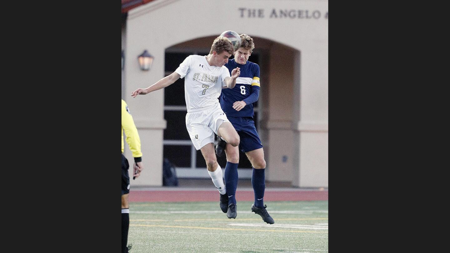 St. Francis' Ian Odermatt battles for a header against Loyola's Henry Smith-Hastie in a Mission League boys' soccer game at St. Francis High School on Monday, January 22, 2018.