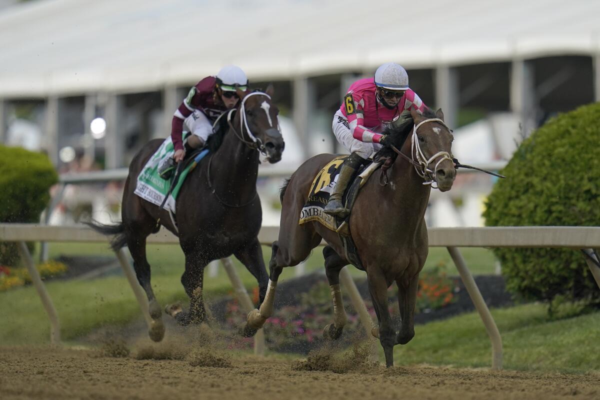 Rombauer, right, breaks away from Midnight Bourbon moments before crossing the finish line to win the Preakness.