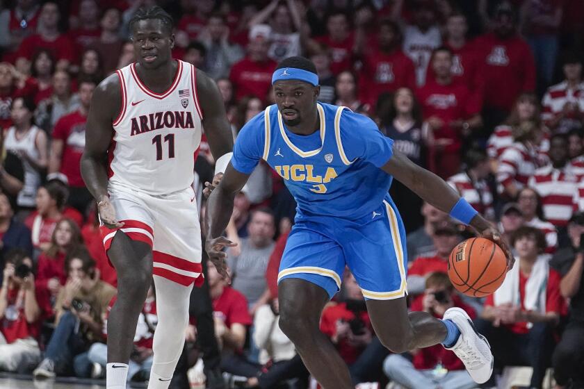 UCLA's Adem Bona (3) starts a fast break after stealing the ball from Arizona's Oumar Ballo.