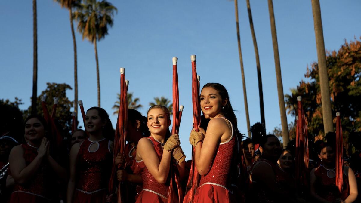 Abby Taylor, left, and Macey Glassco of the Albertville High School Band of Albertville, Ala., take in the excitement before the start of the Rose Parade.