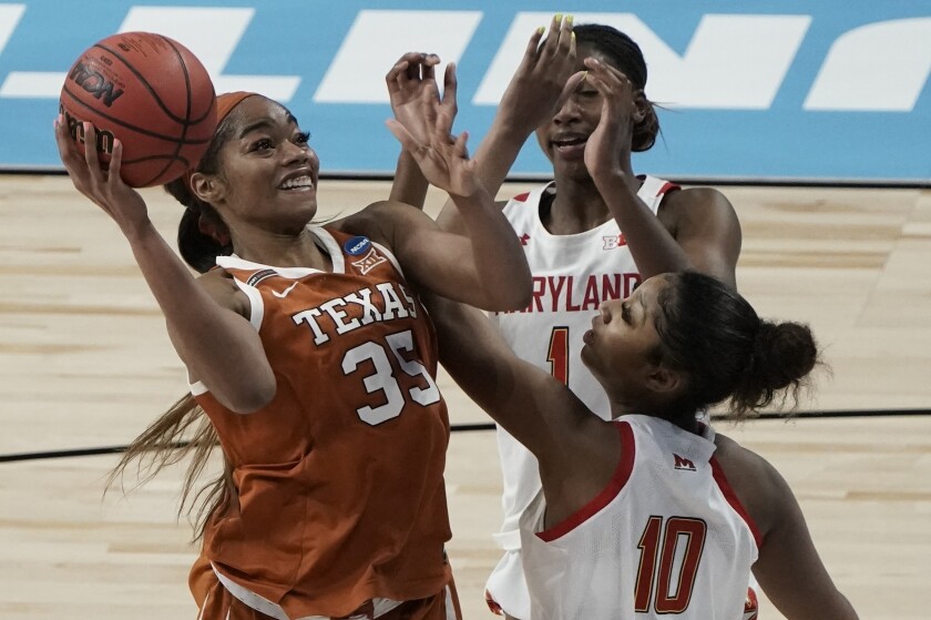 FILE - Texas's Charli Collier shoots over Maryland's Angel Reese during the second half of an NCAA college basketball game in the Sweet 16 round of the Women's NCAA tournament in San Antonio, in this Sunday, March 28, 2021, file photo. The Dallas Wings basically control the WNBA draft on Thursday night, April 15, 2021, with the top two picks and four first-round choices. The Wings could draft Texas' Charli Collier with one of the top picks.(AP Photo/Morry Gash, File)