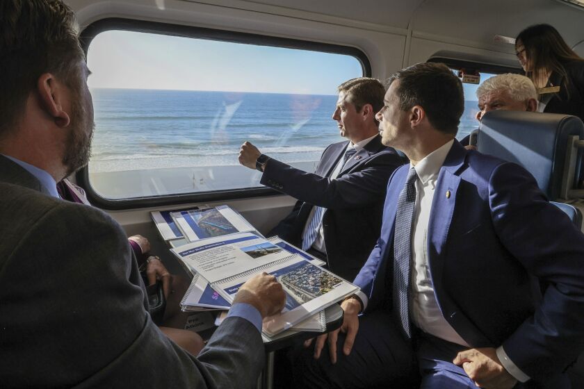 U.S. Transportation Secretary Pete Buttigieg (right) rides the bluff at Del Mar.