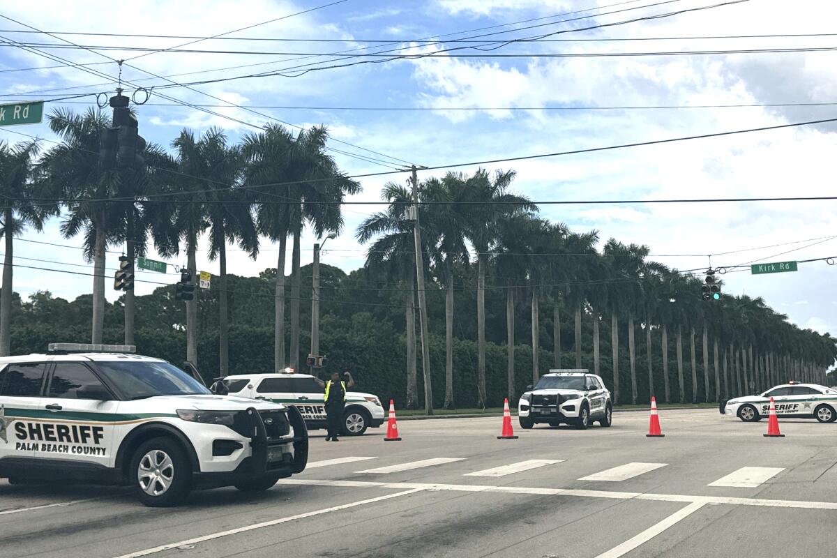 Police vehicles block an intersection