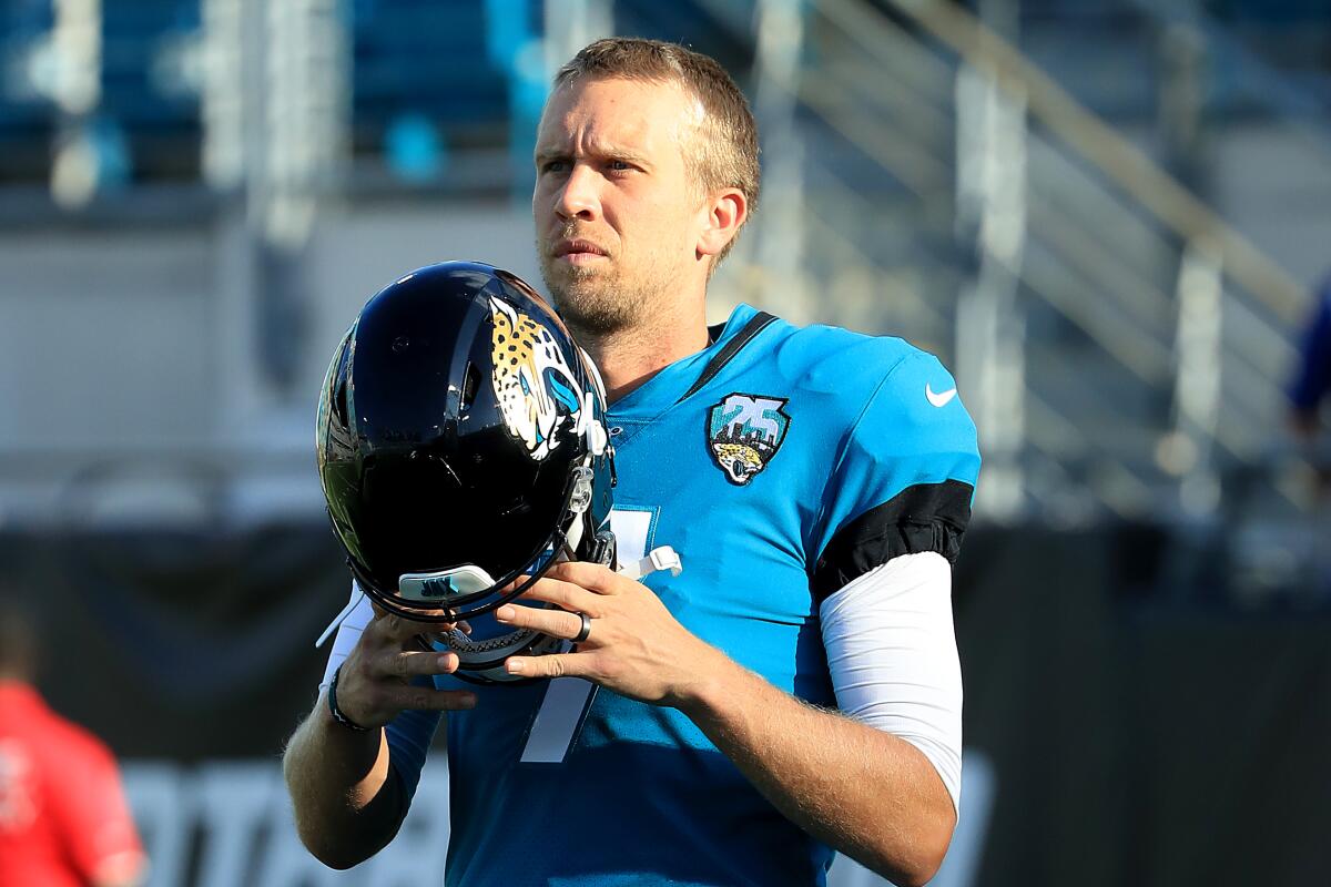 Jacksonville Jaguars quarterback Nick Foles prepares to put on his helmet before a preseason game against the Atlanta Falcons.