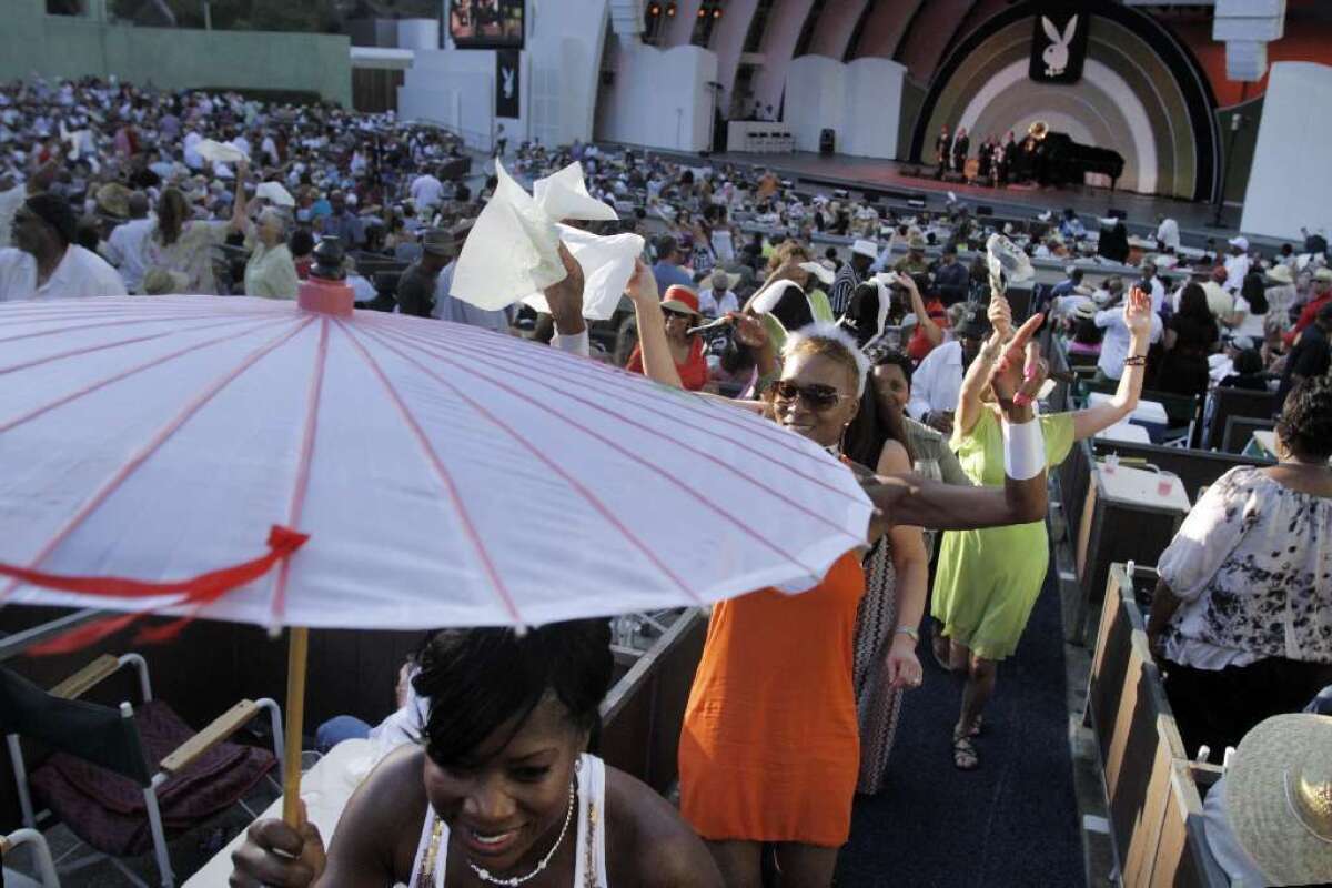Revelers dance and parade in the aisles during the 2012 Playboy Jazz festival.